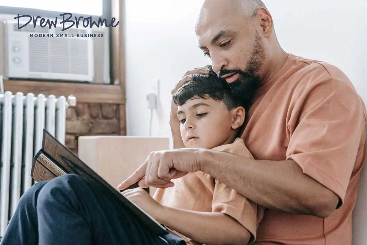 And affectionate father enjoying some instructional time with his son helping him read a book together