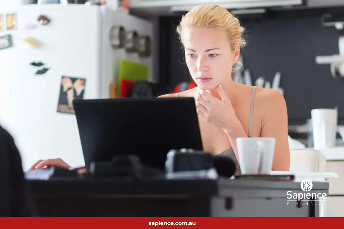 small business woman working on laptop compute at kitchen tabnle