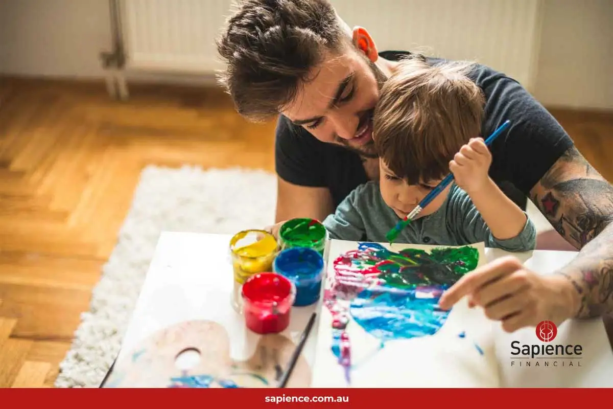 father and young son painting toghether