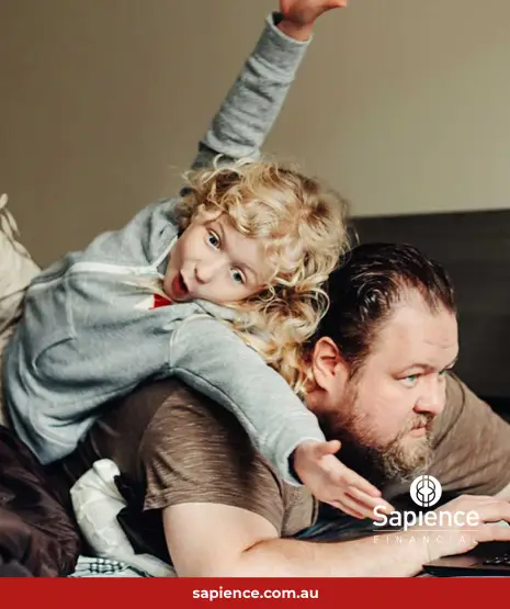daughter jumping on father while he is working