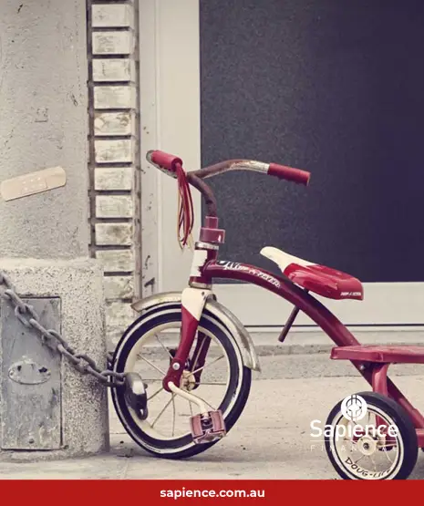 red bicycle chained to lamp pole