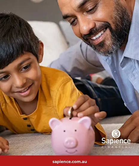father and son with pink piggybank