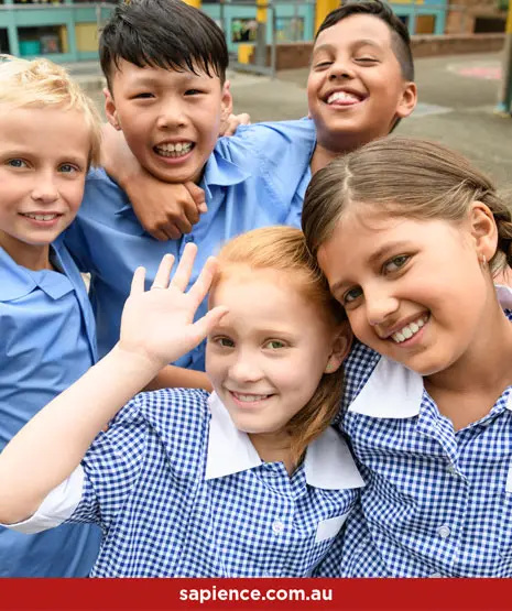 happy primary school children waving at camera