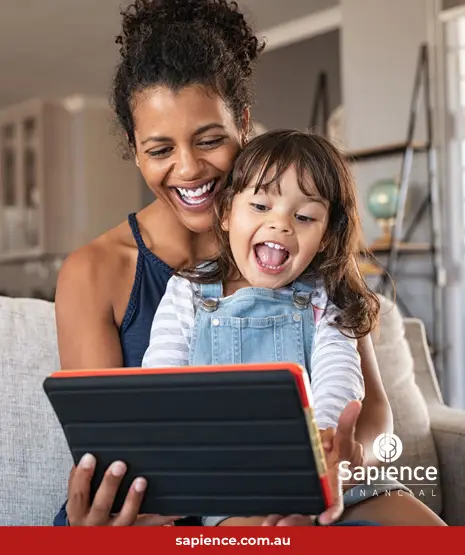 mother and young daughter laughing at content displaying on a tablet device