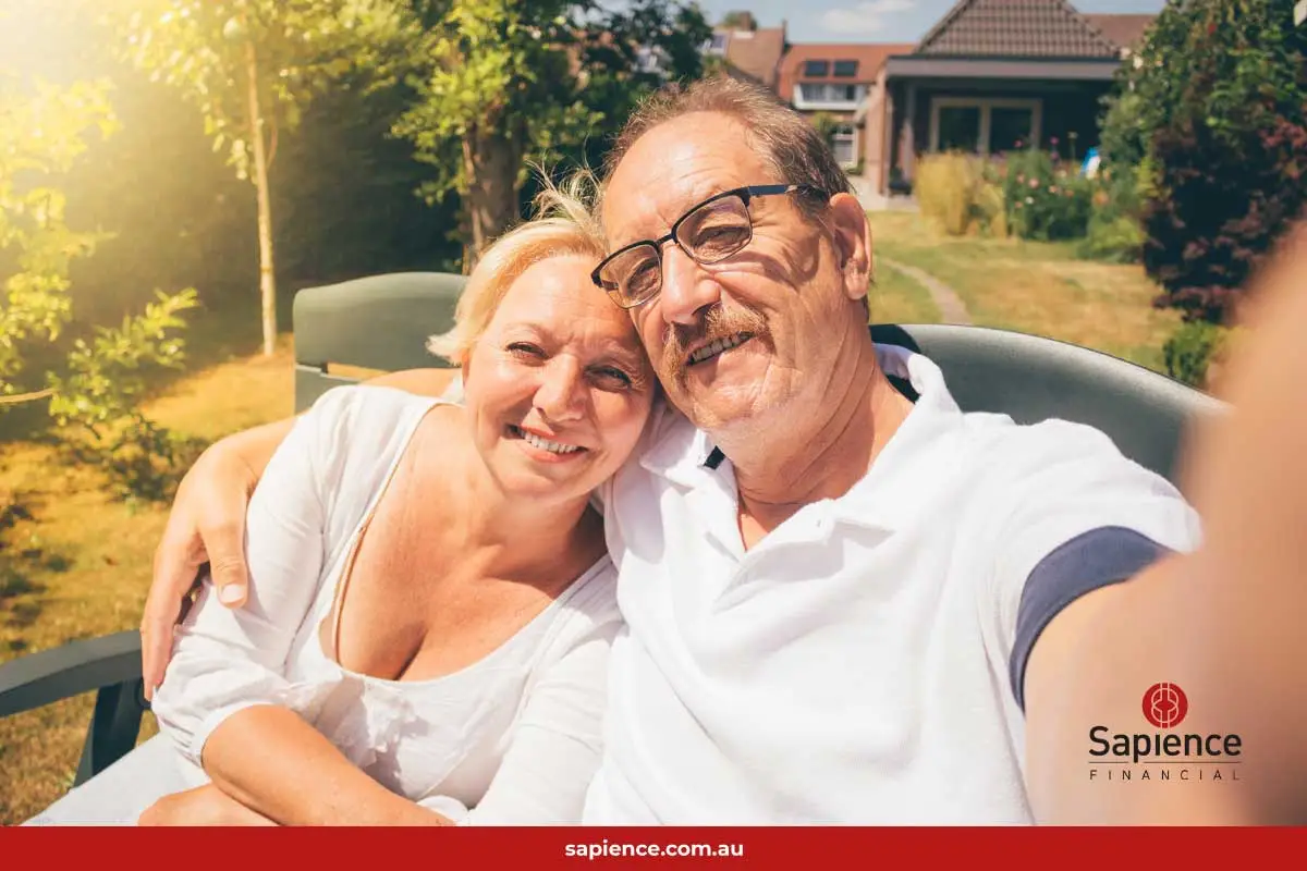 wife and husband taking a selfie in front of their family home